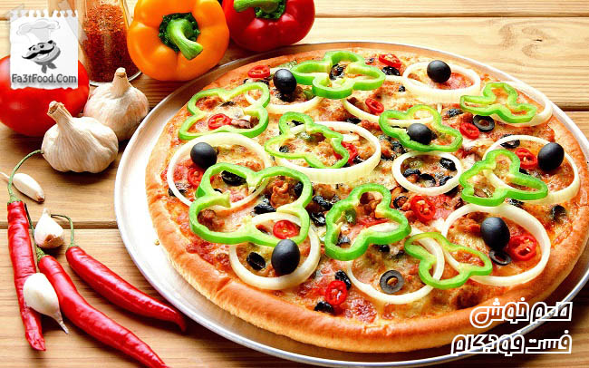 Pizza on metal dish and vegetable